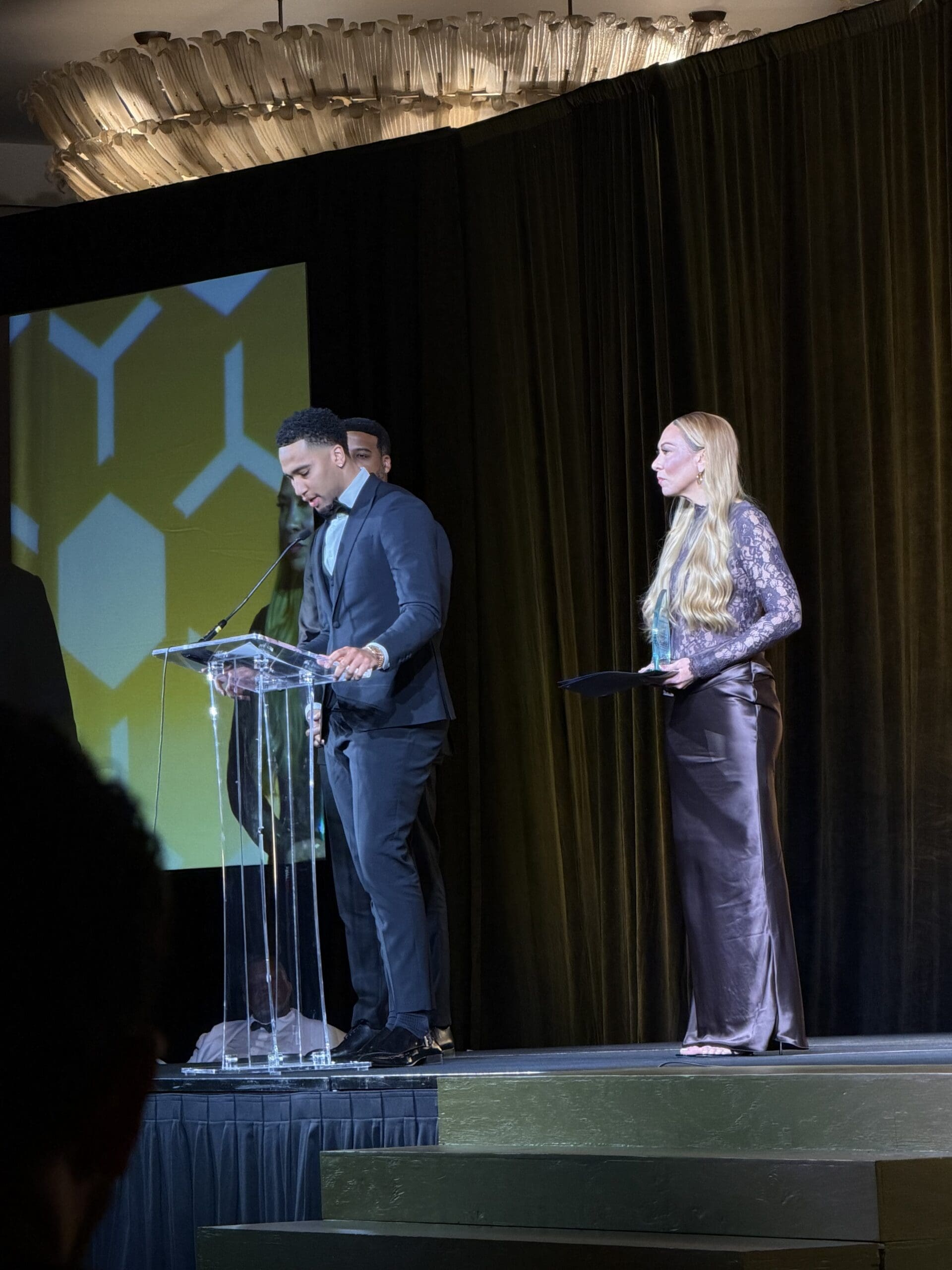 People on stage at an award ceremony.