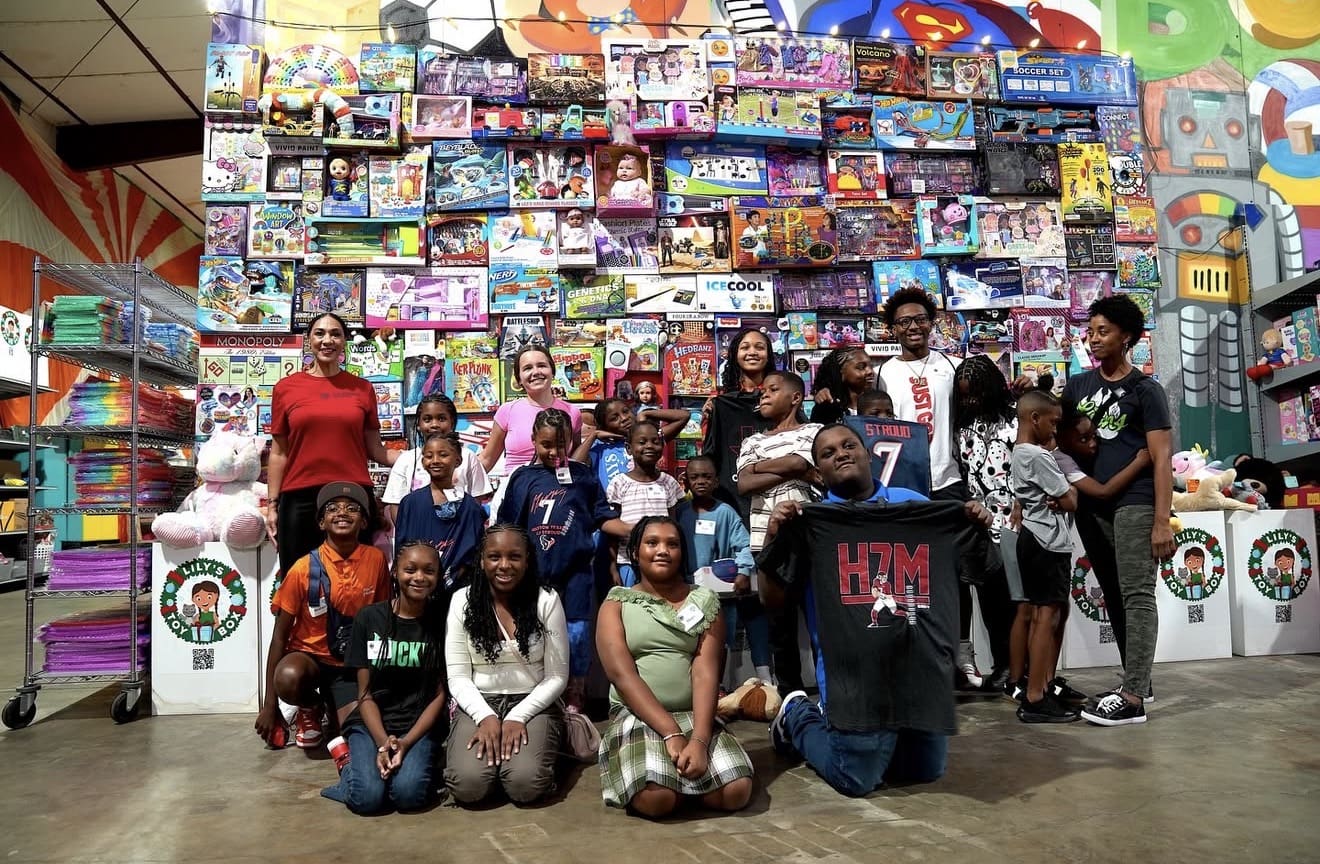 Group of people in front of toy display.