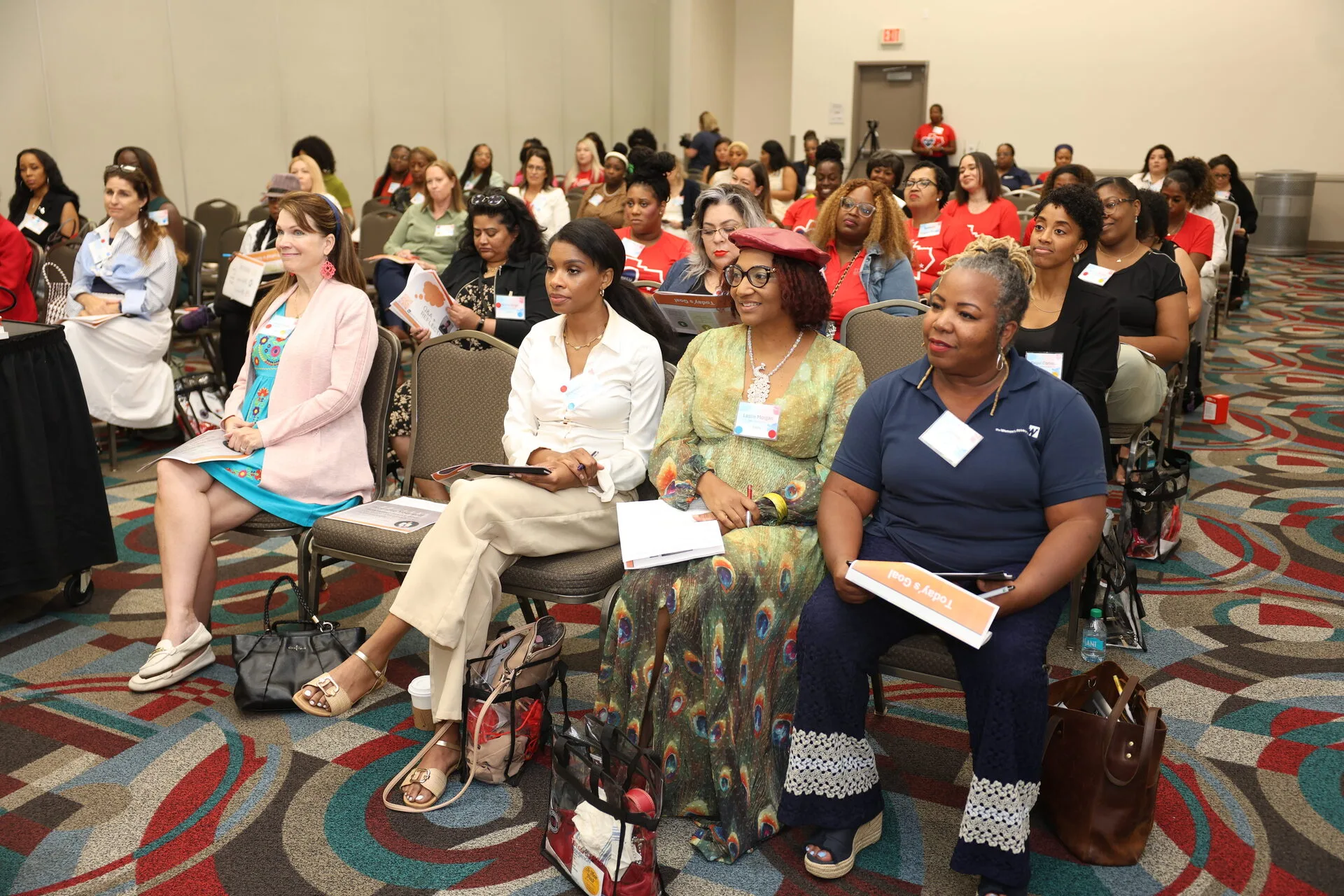 Audience attentively listening during a conference session.